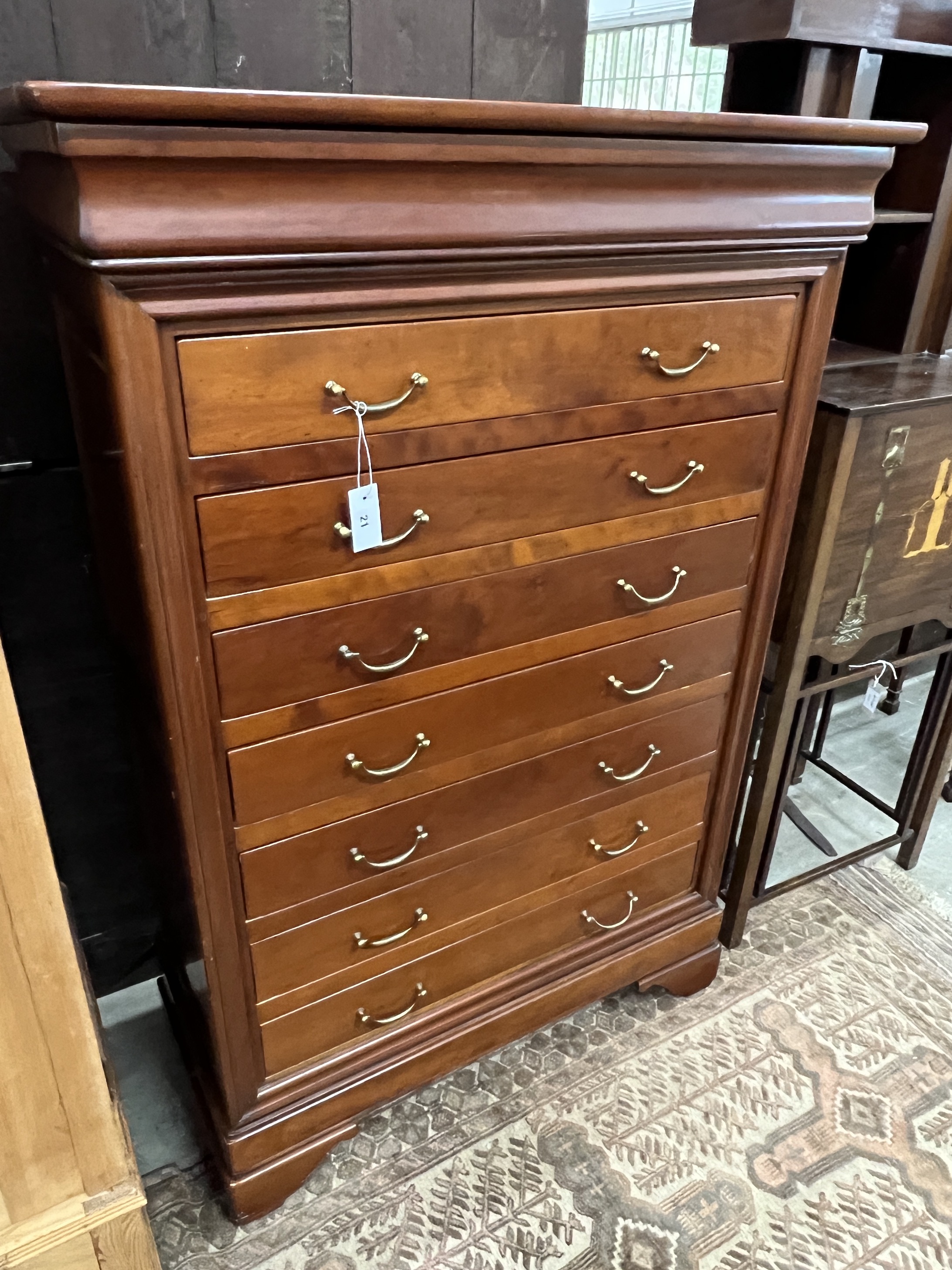 A reproduction French style cherry wood seven drawer semainier, width 99cm, depth 47cm, height 147cm